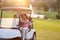 Female Golfers Driving Buggy Along Fairway Of Golf Course