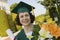 Female Graduate Holding Degree And Bouquet