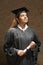 Female graduate holding a diploma