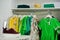 Female green colorful clothing set of on the racks and shelves in clothing store brand new modern boutique. Spring summer dress