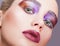 Female green pistachio colour eye with evening violet eyes shadows, white eyelashes and purple lips makeup