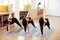 Female group of yogi practicing in Extended side angle pose with inclining, stretching and lifting hand up. Yoga classes