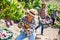 Female grower measuring sugar content of mango during harvest