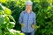 Female grower with ripe pods of green beans on vegetable garden