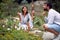 Female guide explaining beautiful plants to a male visitor