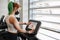 Female gym employee attaching sign onto treadmill social distancing rules