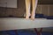 Female gymnast practicing gymnastics on the balance beam