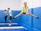 Female gymnast practicing middle split on trampoline