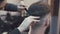 Female haircutter cutting the male hair in the barbershop 4K