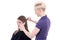 Female hairdresser curling hair to young beautiful woman isolate