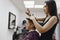 a female hairdresser cuts the ends of women& x27;s hair in a beauty salon, close-up