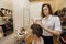 Female hairstylist cutting male customer\'s hair in shop