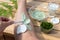 Female hand applying healing cream with Wood Fern leaves and yogurt on her leg