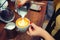 Female hand barista with a white cup of fragrant cappuccino