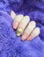 Female hand beautiful colored manicure closeup elegant