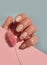 Female hand beautiful polish  fashion color  health  clean  salon luxury manicure on a colored background