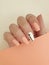 Female hand beautiful polish manicure wellness on a colored background