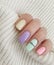 Female hand beautiful   style  creativity  sweater   fashionable   colorful manicure on a colored background