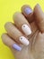 Female hand beautiful stylish delicate pastel manicure on a colored background