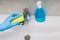 Female hand cleaning sink tap faucet in bathroom to disinfect from virus or bacteria and clean limescale prevent infection
