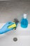 Female hand cleaning water tap with sponge in bathroom. Chores concept
