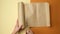 Female hand cuts a piece of paper with scissors from a roll of brown parchment paper