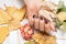 Female hand with dark red nail design. Brown nail polish manicured hand. Woman hand hold yellow autumn leaf