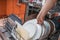 Female hand and dirty plates in dishwasher. Housework concept