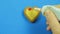 Female hand draws banned emoticons on heart shaped cookies on a blue background