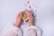 Female Hand Dressed in a White Blouse Holding White Cup of Coffee Blue Background with Red Confetti in Shape of Hearts Valentine