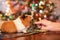 Female hand feed guinea pig with parsley with christmas tree on background