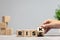 Female hand fliping wooden cubes with word rise to risk on the table. Copyspace for ad, offer.