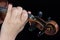 Female hand on fretboard violin. Fingers clamp the strings. For coverage of music news. Close up. Black background.