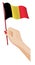 Female hand gently holds small flag of Belgium. Holiday design element. Cartoon vector on white background