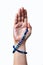 A female hand in a gloss with a blue gemstone braselet in a blessing gesture