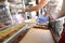 Female hand in glove holds plate of salad in cafe.