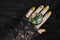 Female hand with green nail design. Multichrome shimmer Halloween nail polish manicure