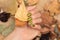 Female hand with green nail design. Woman hand hold dry leaves. Green autumn nail polish manicure with golden glitter