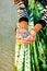 Female hand having bunch of small crabs in her hands. woman catching carbs in the sea,