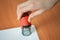 Female hand hold rubber stamps over blank paper corner at office table, closeup detail shoot.