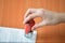 Female hand hold rubber stamps over documents and papers at office table, closeup detail shoot.