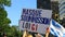 Female hand holding banner in protest