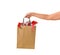 Female hand holding blank brown papaer shopping bags full of gift boxes ornamented