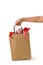 Female hand holding blank brown papaer shopping bags full of gift boxes ornamented