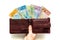Female hand holding brown wallet with New Zealand dollars sticking out, All kinds of banknotes, White background, Financial