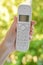 Female hand holding cordless landline telephone receiver outdoor