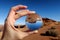 Female Hand Holding a Crystal Globe with an Upside-Down Reflection of a Desert Landscape