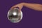 Female hand holding a disco ball