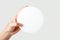 Female hand holding empty circle round shape mockup light background