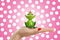 Female hand is holding frog prince, concept for dating, love and